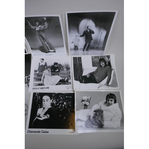 103 - A quantity of black and white press and promotional photographs of musicians, including Elvis, Madne... 