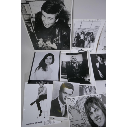 103 - A quantity of black and white press and promotional photographs of musicians, including Elvis, Madne... 