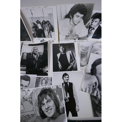 103 - A quantity of black and white press and promotional photographs of musicians, including Elvis, Madne... 