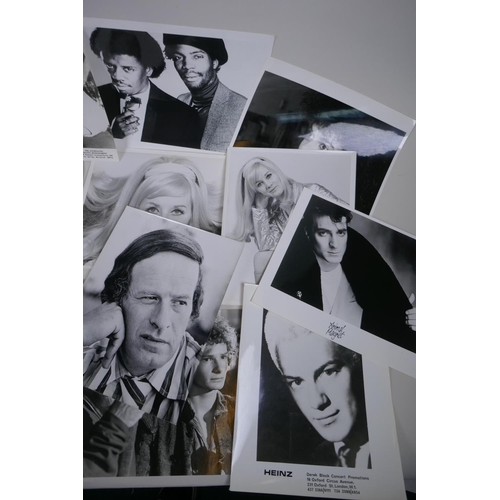 103 - A quantity of black and white press and promotional photographs of musicians, including Elvis, Madne... 