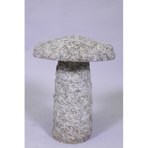 1030 - A small granite saddle stone, 30cm diameter, 37cm high