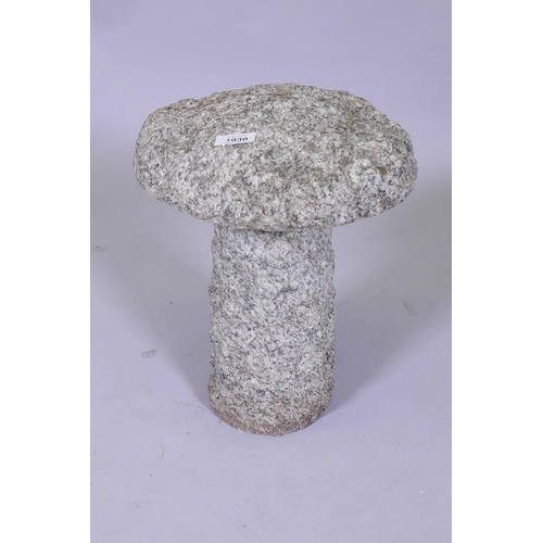 1030 - A small granite saddle stone, 30cm diameter, 37cm high