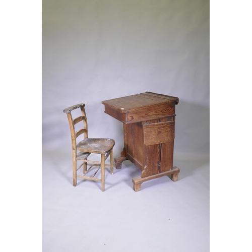 1034 - A Victorian pitch pine desk, with pen tray and inkwell, lift up top and side flap and door to back, ... 