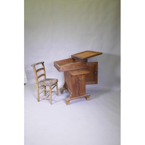 1034 - A Victorian pitch pine desk, with pen tray and inkwell, lift up top and side flap and door to back, ... 