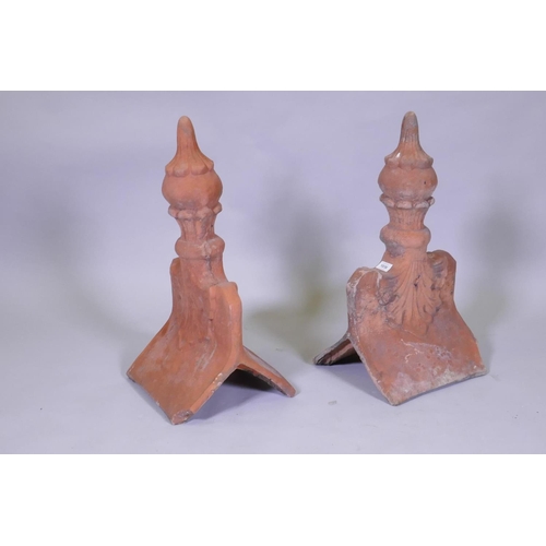 1036 - A pair of terracotta roof finial tiles, 60cm high