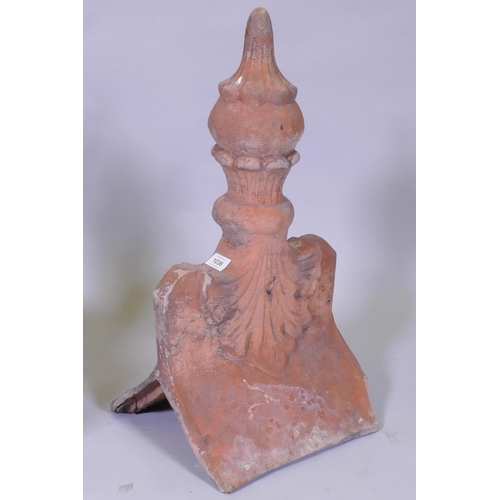 1036 - A pair of terracotta roof finial tiles, 60cm high