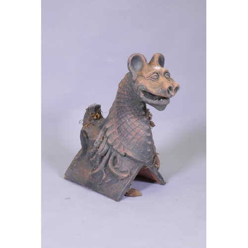 1037 - A terracotta ridge tile in the form of a gargoyle, 48cm high