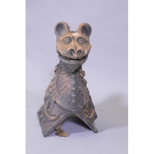 1037 - A terracotta ridge tile in the form of a gargoyle, 48cm high