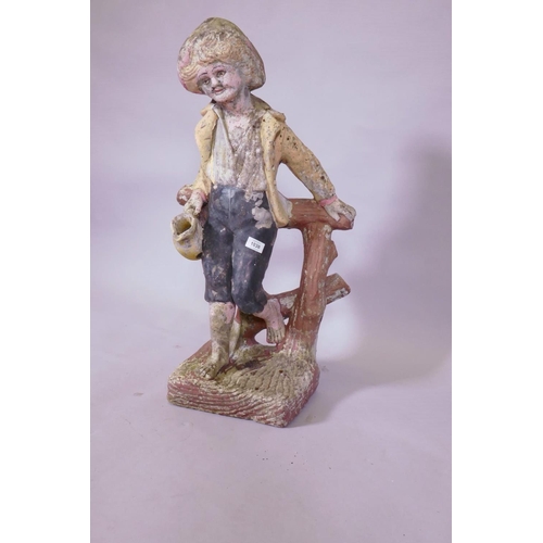 1038 - A painted concrete garden figure of a young boy leaning on a tree stump, 80cm high