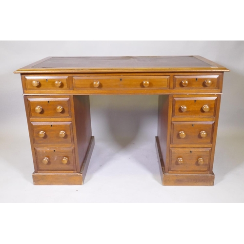 1045 - A Victorian mahogany nine drawer pedestal desk, with moulded feet details, wood knobs and inset rexi... 