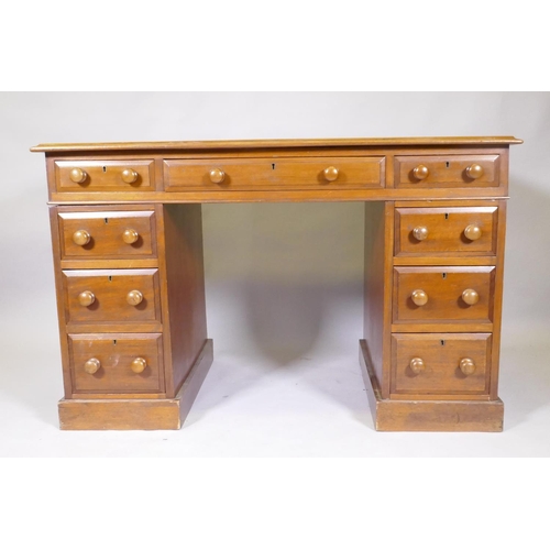 1045 - A Victorian mahogany nine drawer pedestal desk, with moulded feet details, wood knobs and inset rexi... 