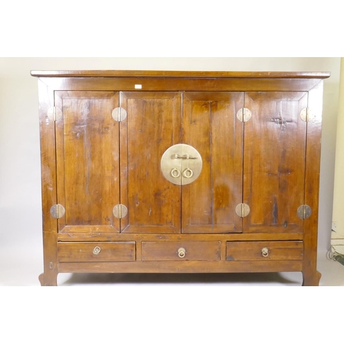 1048 - A Chinese hardwood cabinet with brass mounts and folding doors, raised on shaped supports, 186 x 64 ... 