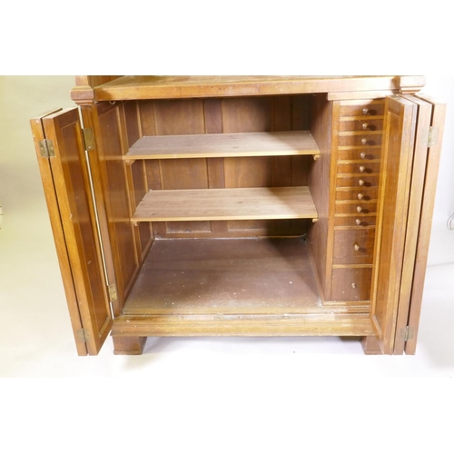 1050 - A late C19th/early C20th walnut tobacconist's shop cabinet, the roll top opening to reveal drawers o... 