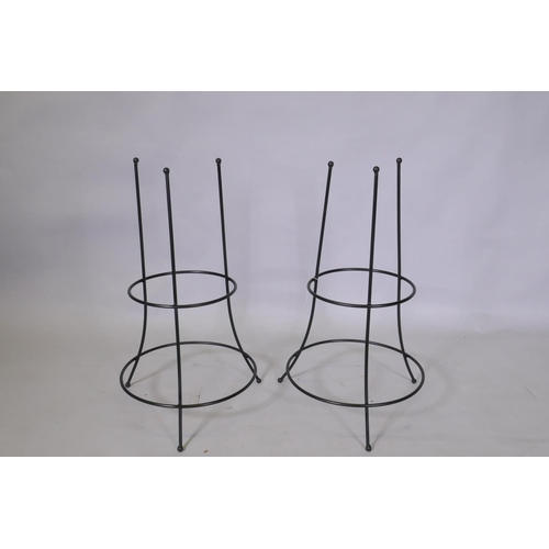 1057 - A pair of wrought metal plant supports, 73cm high