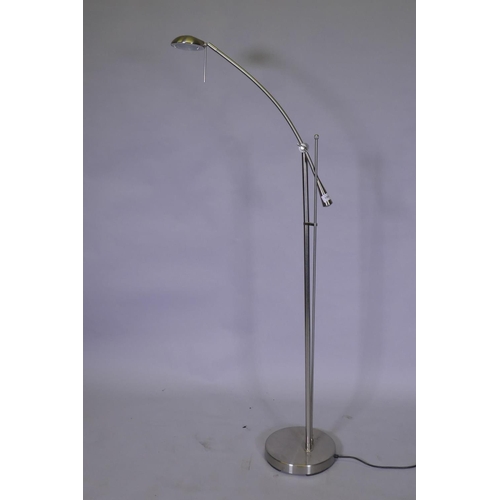 1063 - A brushed metal adjustable floor lamp, 145cm high