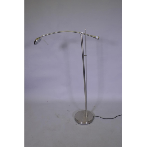 1063 - A brushed metal adjustable floor lamp, 145cm high