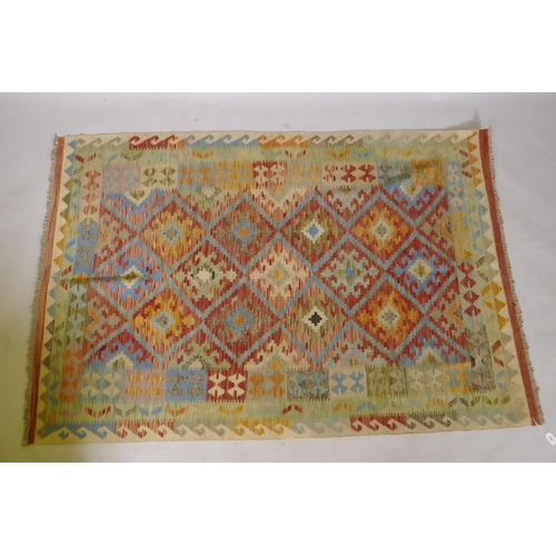 1067 - An Afghan multicolour ground wool kilim, with geometric design, 126 x 186cm