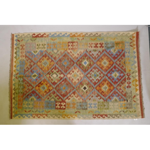 1067 - An Afghan multicolour ground wool kilim, with geometric design, 126 x 186cm