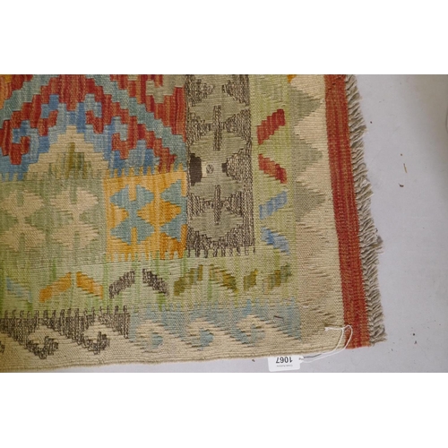 1067 - An Afghan multicolour ground wool kilim, with geometric design, 126 x 186cm