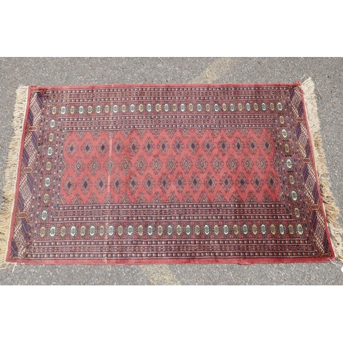 1071 - A Turkish terracotta ground wool rug with all over geometric design, 98 x 154cm