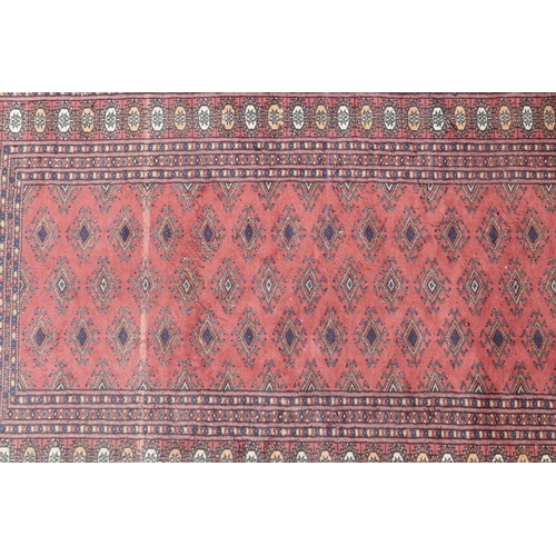 1071 - A Turkish terracotta ground wool rug with all over geometric design, 98 x 154cm