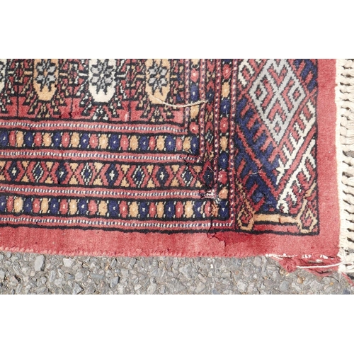 1071 - A Turkish terracotta ground wool rug with all over geometric design, 98 x 154cm