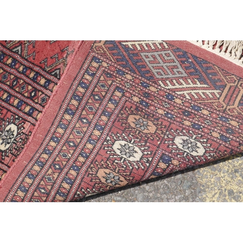 1071 - A Turkish terracotta ground wool rug with all over geometric design, 98 x 154cm