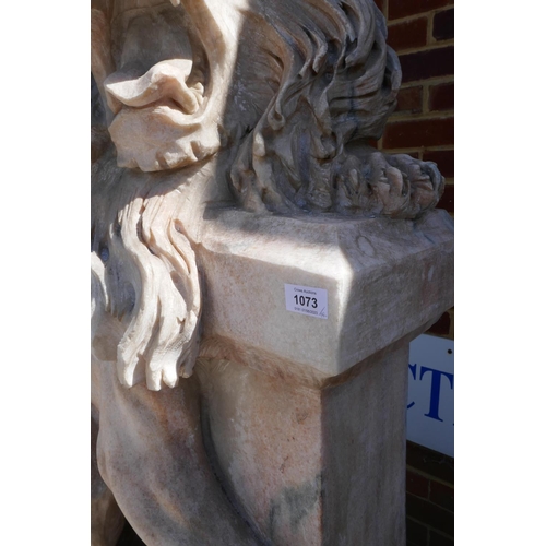 1073 - A pair of carved marble figures of lions mounted on plinths, 166cm high