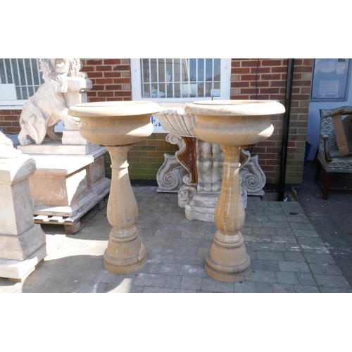 1080 - A pair of stone cast urns on stands, 60cm diameter, 118cm high