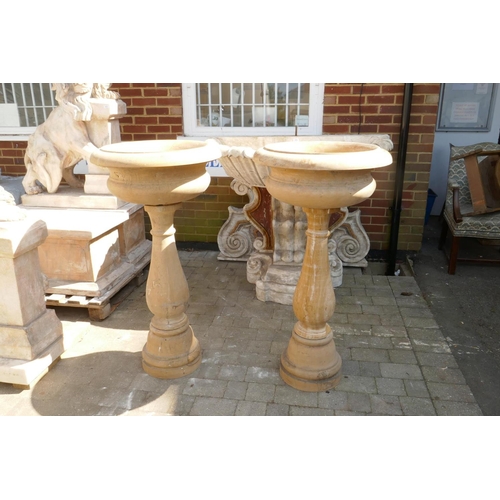 1080 - A pair of stone cast urns on stands, 60cm diameter, 118cm high