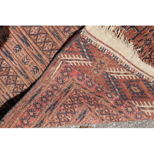 1083 - An antique wool terracotta ground bokhara carpet, 148 x 226cm, AF