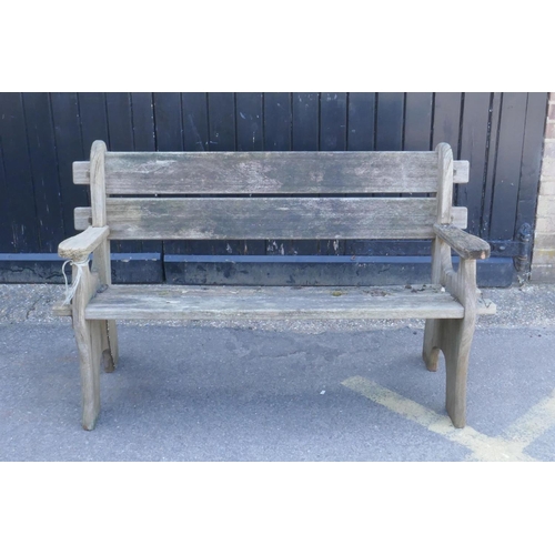 1084 - A weathered wood garden bench, 130cm wide