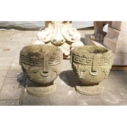 1085 - A pair of weathered concrete garden urns, 26cm high