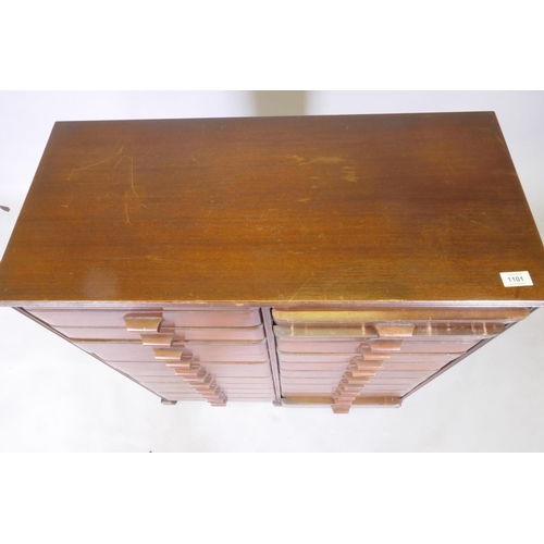 1101 - A mid century mahogany filing cabinet comprising 22 slide drawers, 80 x 37 x 90cm