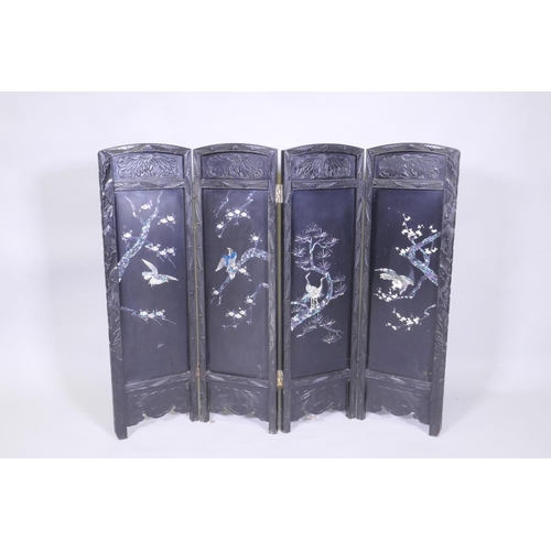 112 - An antique Japanese four fold black lacquer screen with inlaid mother of pearl and abalone decoratio... 