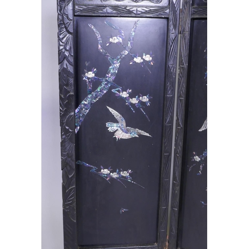 112 - An antique Japanese four fold black lacquer screen with inlaid mother of pearl and abalone decoratio... 