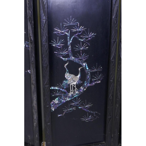 112 - An antique Japanese four fold black lacquer screen with inlaid mother of pearl and abalone decoratio... 