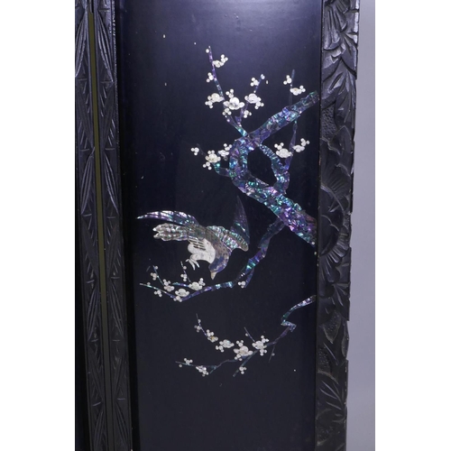 112 - An antique Japanese four fold black lacquer screen with inlaid mother of pearl and abalone decoratio... 