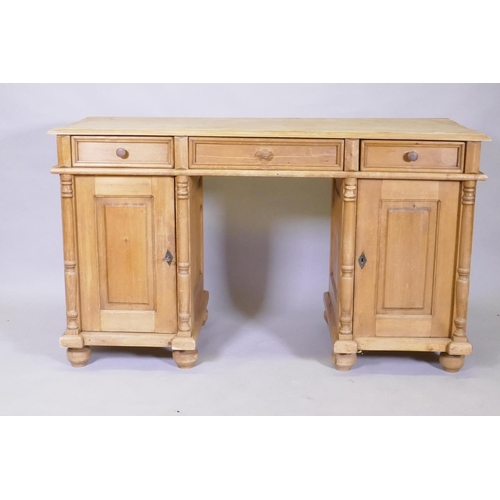 1127 - A C19th continental pine kneehole desk, with three drawers over two cupboards fitted with shelves, 1... 