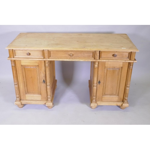 1127 - A C19th continental pine kneehole desk, with three drawers over two cupboards fitted with shelves, 1... 