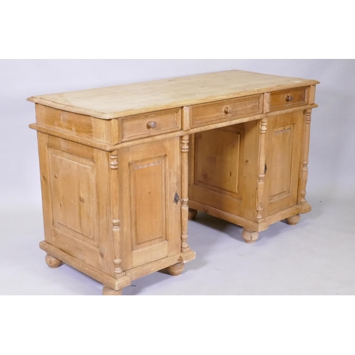 1127 - A C19th continental pine kneehole desk, with three drawers over two cupboards fitted with shelves, 1... 