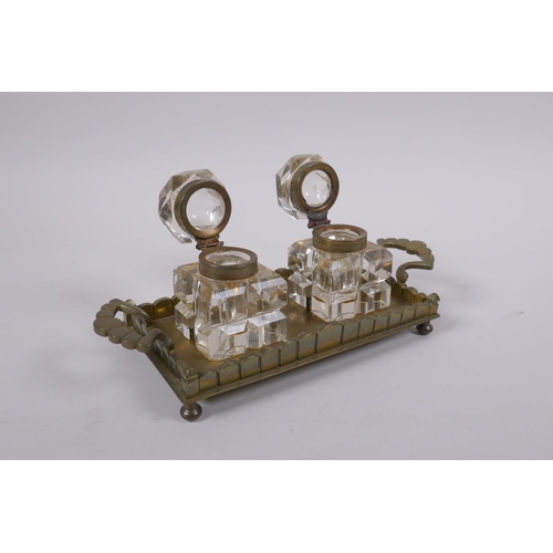 114 - An antique brass and glass twin inkwell desk stand, 21 x 9cm