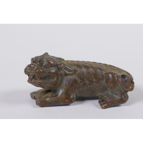 118 - A Japanese style bronze okimono in the form of a temple lion, 7cm long