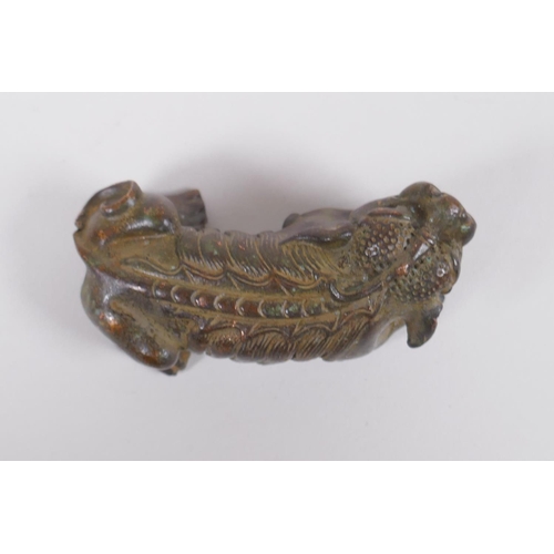 118 - A Japanese style bronze okimono in the form of a temple lion, 7cm long