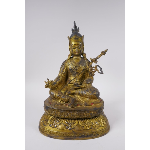 119 - A Tibetan gilt bronzed metal figure of Buddha seated on a lotus throne, impressed double vajra mark ... 