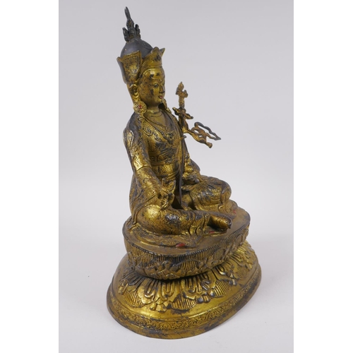 119 - A Tibetan gilt bronzed metal figure of Buddha seated on a lotus throne, impressed double vajra mark ... 