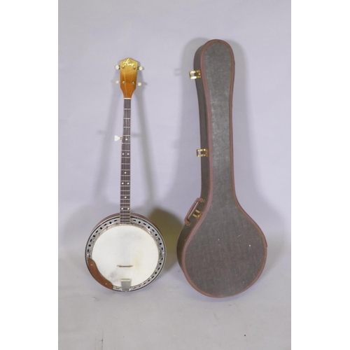 134 - A 1950s Kay five string banjo, with a carry case, 98cm long, 34cm diameter