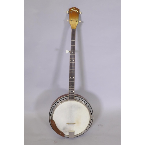 134 - A 1950s Kay five string banjo, with a carry case, 98cm long, 34cm diameter