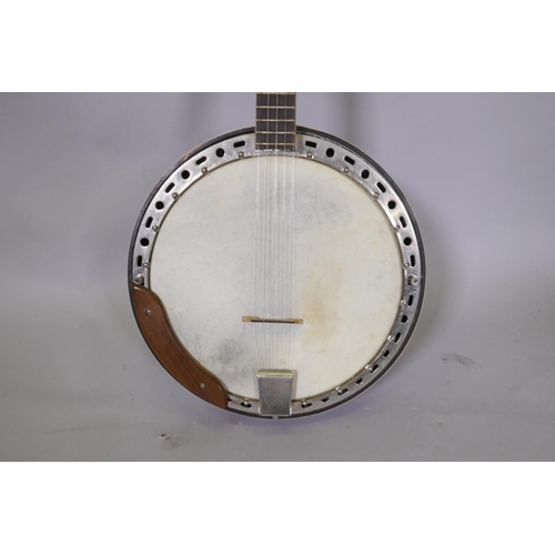 134 - A 1950s Kay five string banjo, with a carry case, 98cm long, 34cm diameter