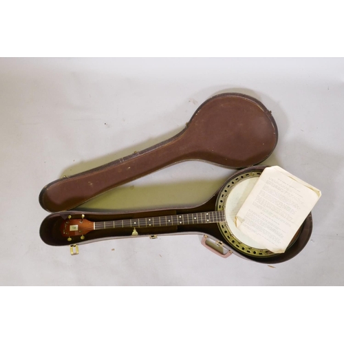 134 - A 1950s Kay five string banjo, with a carry case, 98cm long, 34cm diameter